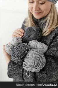 close up woman holding knitting yarns
