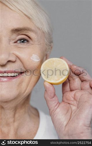 close up woman holding lemon slice 2