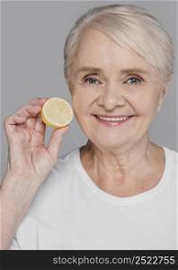 close up woman holding lemon slice