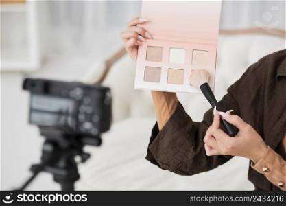 close up woman holding make up colors