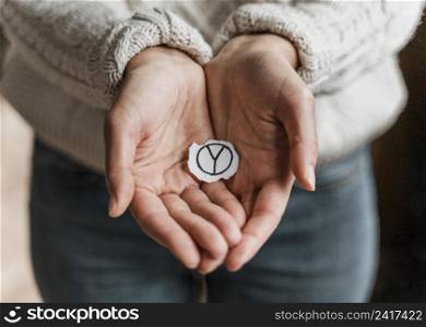 close up woman holding peace sign