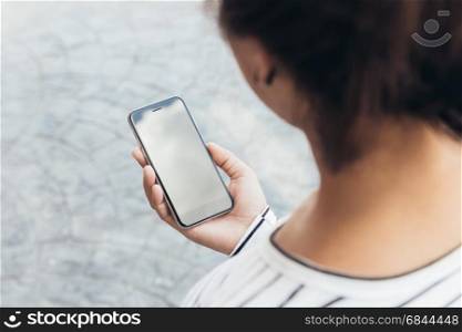 close up woman holding phone lifestyle in the city, third-person view