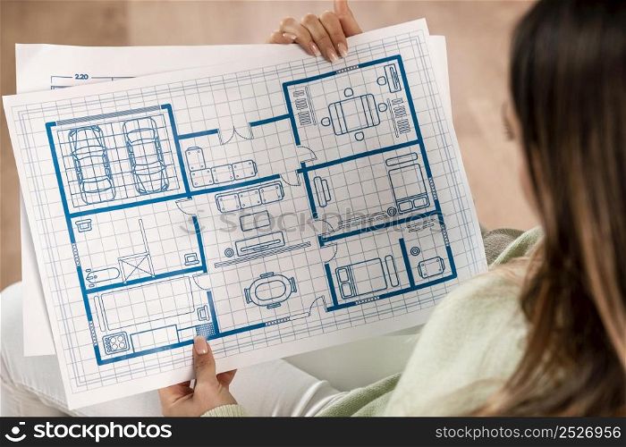 close up woman holding plans