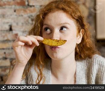 close up woman holding potato