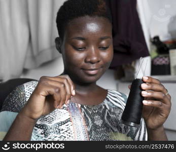 close up woman holding thread