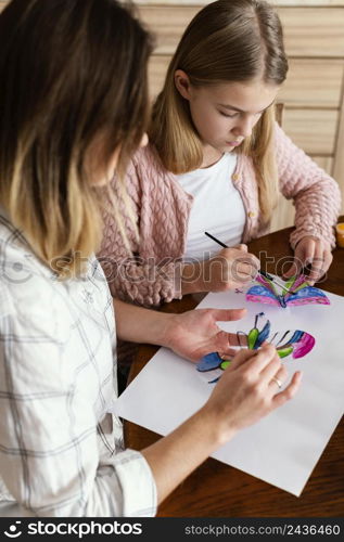 close up woman kid painting butterflies