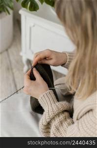 close up woman knitting with metallic needles