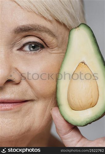 close up woman posing with avocado