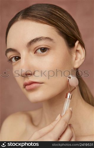 close up woman posing with face tool
