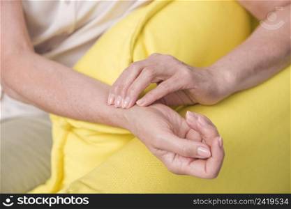 close up woman s hand checking wrist pulse