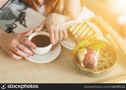 close up woman s hand holding bowl oatmeal with fruits tray