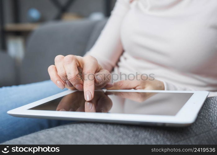 close up woman s hand touching modern digital screen with finger