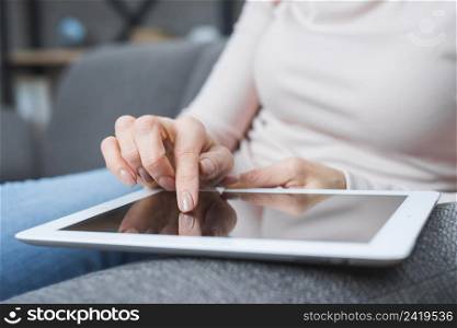close up woman s hand touching modern digital screen with finger