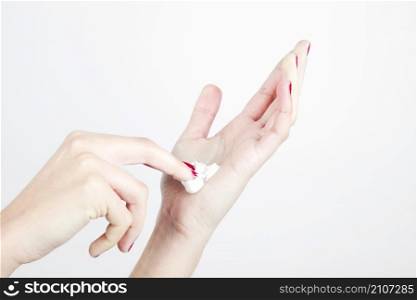 close up woman s hand with moisturizer isolated white background
