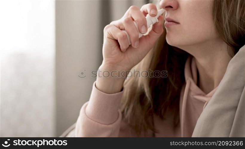 close up woman taking treatment runny nose