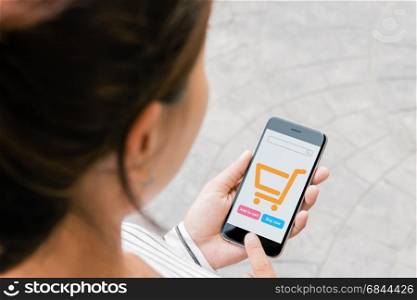 close up woman use phone shopping online on thrid person view