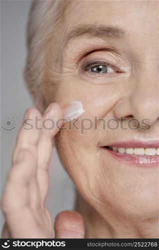 close up woman using face cream 2