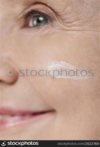 close up woman using face cream