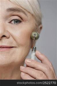 close up woman using face roller