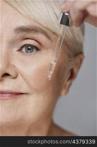 close up woman using face serum