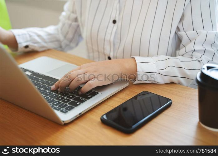 close up woman using laptop in cafe.