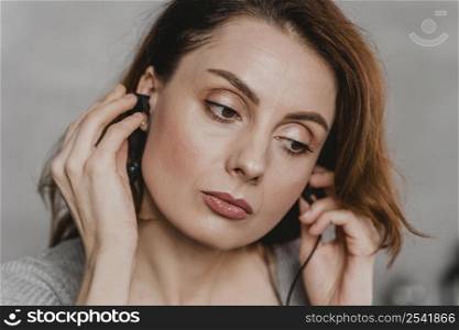 close up woman wearing earphones