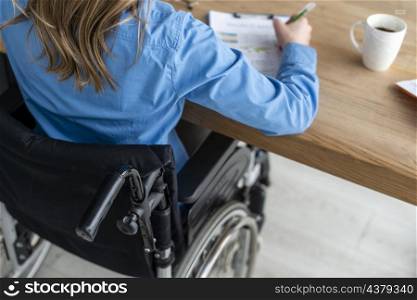 close up woman wheelchair working office