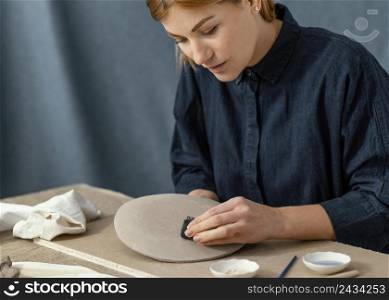 close up woman wiping plate