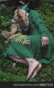 Close up woman with dog lying on green moss in forest concept photo. Top view photography with perennial plants on background. High quality picture for wallpaper, travel blog, magazine, article. Close up woman with dog lying on green moss in forest concept photo