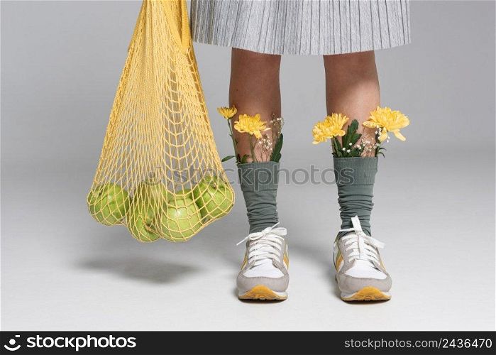 close up woman with flowers socks holding turtle bag