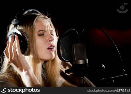 close up woman with headphones singing