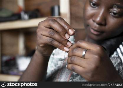 close up woman with needle thread