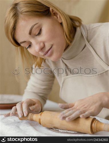 close up woman with rolling pin