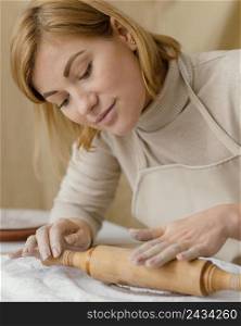 close up woman with rolling pin