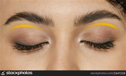 close up woman with yellow make up