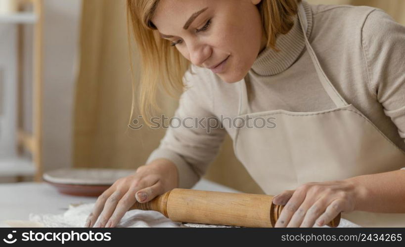 close up woman working with rolling pin 2