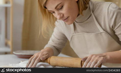 close up woman working with rolling pin 2