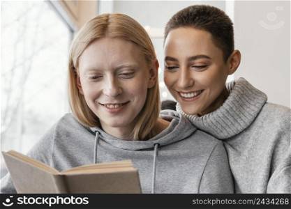 close up women reading together