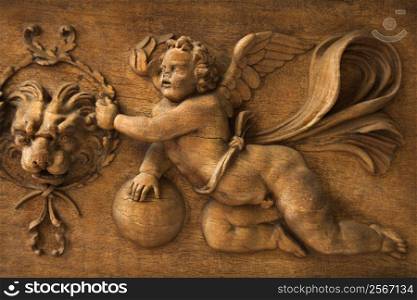 Close-up wood carving of cherub angel in the Vatican Museum, Rome, Italy.