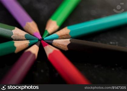 Close-up, wooden crayons arranged in a color wheel.