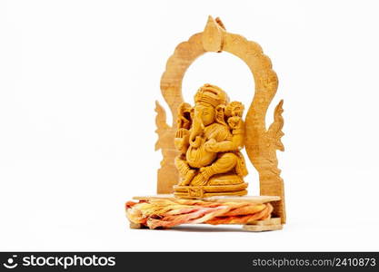 Close up wooden statue of Lord Ganesha on white isolated. Close up wooden statue of Lord Ganesha on white