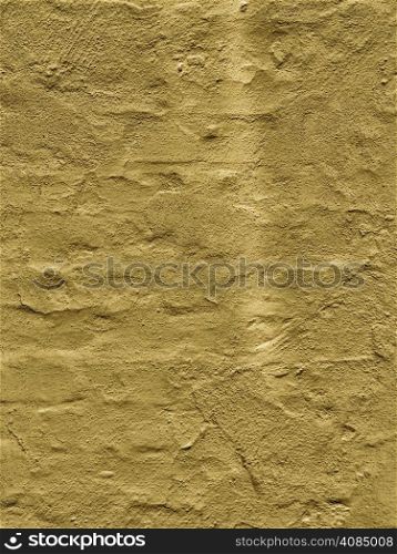 Close up yellow brown paint uneven old concrete wall background or texture