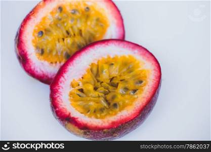 Close up yellow color passion fruit pulp and seed in small ceramic bowl isolated on white