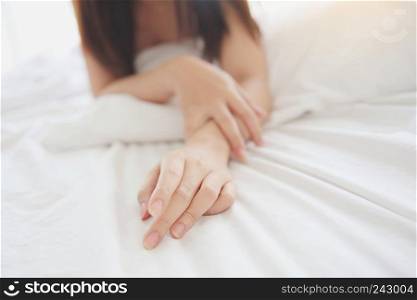 Close up young asian woman hand on bed