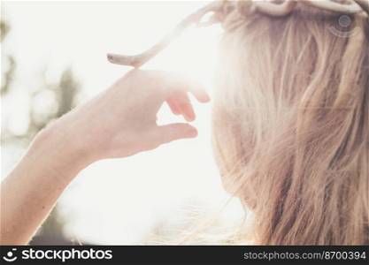Close up young blond lady concept photo. Hand blocking sun. Sunny summer day. Rear view photography with highlight on background. High quality picture for wallpaper, travel blog, magazine, article. Close up young blond lady concept photo