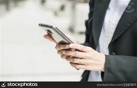 close up young businesswoman using smartphone