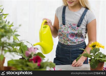 close up young girl watering flowers