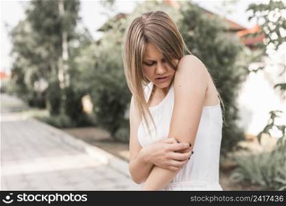 close up young woman having pain elbow