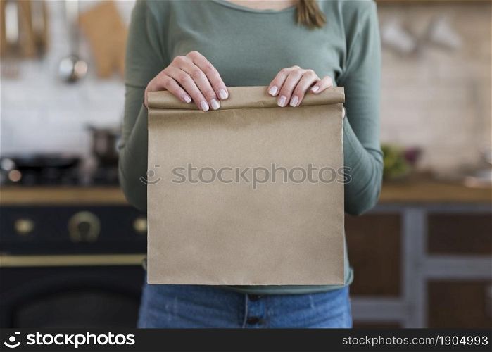 close up young woman holding paper bag. Beautiful photo. close up young woman holding paper bag