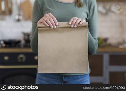 close up young woman holding paper bag. Beautiful photo. close up young woman holding paper bag